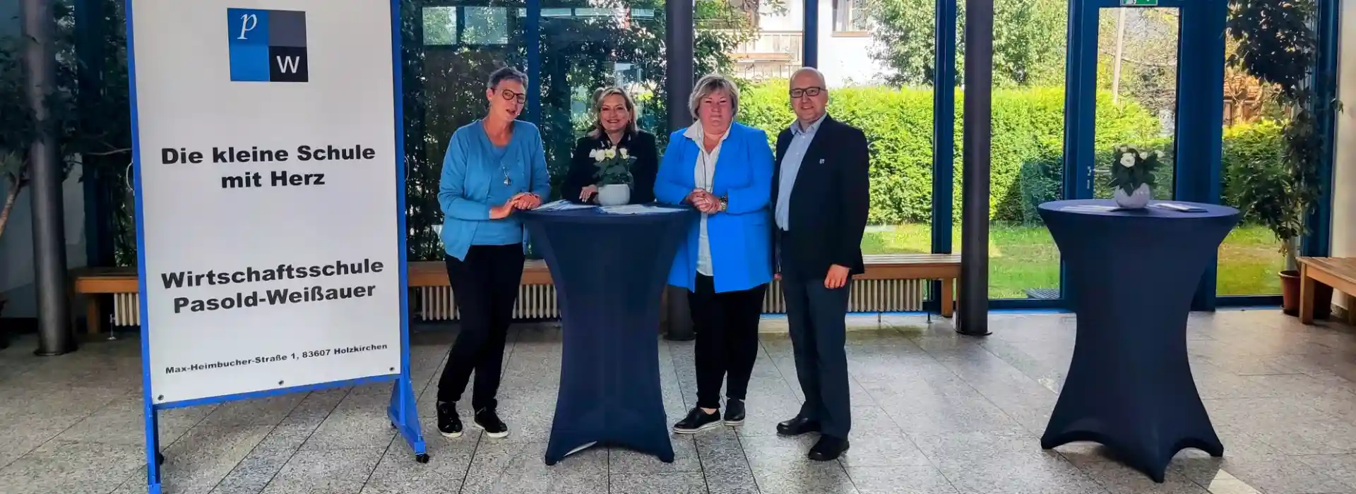 Empfangsbereich der Schule mit vier Personen